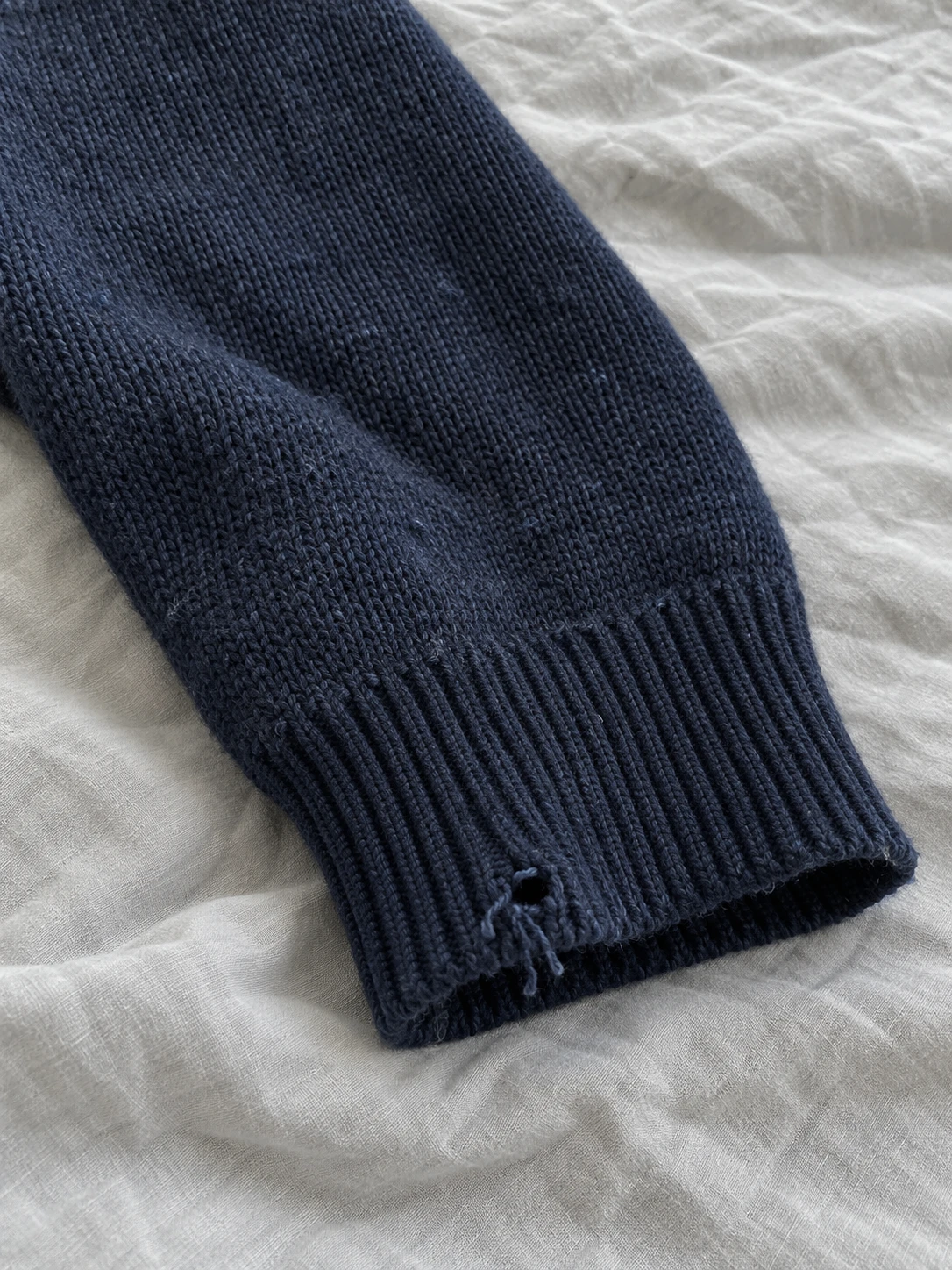 Original knit cuff with visible wear